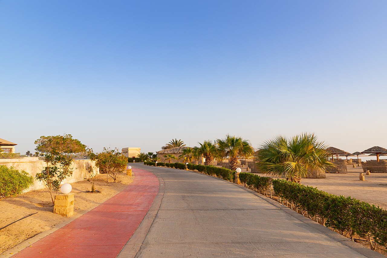 A paved promenade with palms and low walls in Soma Bay, photographed in 2021